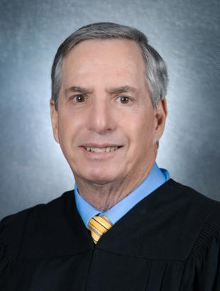 Senior Judge Jay P. Cohen